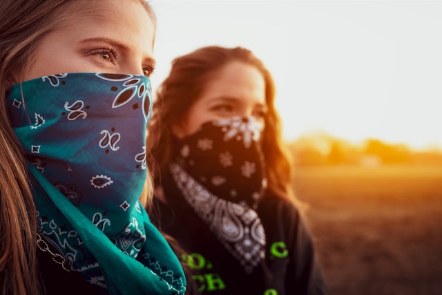 girl in green and white floral scarf