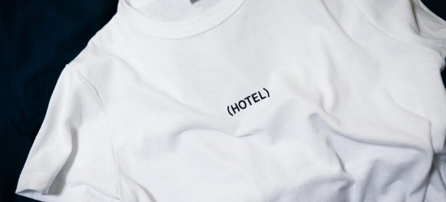 white hotel-printed crew-neck shirt on black surface