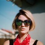 woman wearing sunglasses and scarf